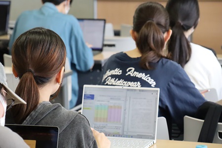 メモを取りながら長井市長の講義を聞く学生たち